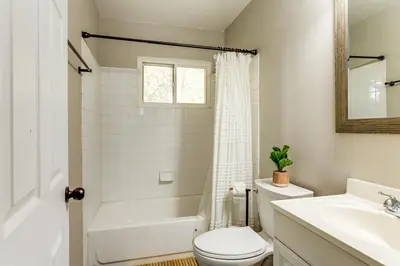 a bathroom with a toilet and a tub and a sink at 6 Mi to Downtown Cincy Group-Friendly Townhome! in Cincinnati