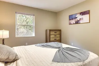 a bedroom with a bed with a dresser and a window at 6 Mi to Downtown Cincy Group-Friendly Townhome! in Cincinnati