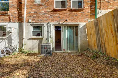 an empty yard in front of a brick building at 6 Mi to Downtown Cincy Group-Friendly Townhome! in Cincinnati