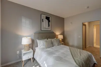 a bedroom with a large white bed and two lamps at Landing Stylish 1BD Yoga Studio Gym in Grove City