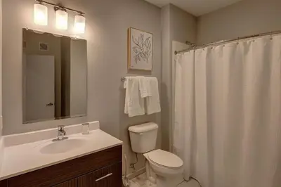 a bathroom with a sink and a toilet and a mirror at Landing Stylish 1BD Yoga Studio Gym in Grove City