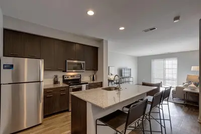 a kitchen with a stainless steel refrigerator and a counter top at Landing Stylish 1BD Yoga Studio Gym in Grove City