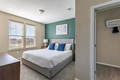 a bedroom with a large bed with blue pillows at Landing Chic 1BD Yoga Studio Gym in Florence