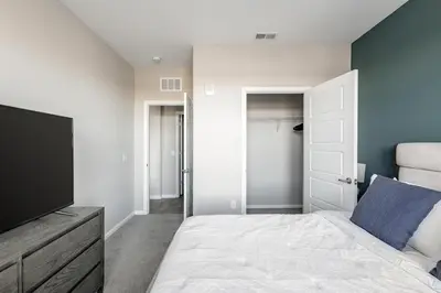 a bedroom with a bed and a flat screen tv at Landing Chic 1BD Yoga Studio Gym in Florence