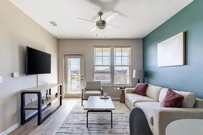 a living room with a couch and a tv at Landing Chic 1BD Yoga Studio Gym in Florence