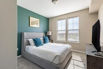 a bedroom with a bed and a flat screen tv at Landing Chic 1BD Yoga Studio Gym in Florence
