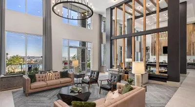 a living room with furniture and large windows at Landing Apartment - Tapestry Ridge in Fort Wright