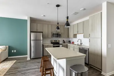 a kitchen with wooden cabinets and a white counter top at Landing Apartment - Tapestry Ridge in Fort Wright