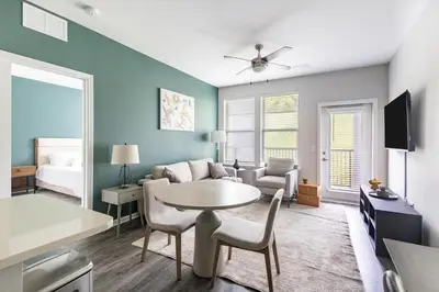 a living room with a table and a couch at Landing Apartment - Tapestry Ridge in Fort Wright