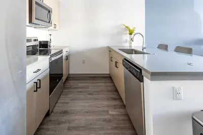 a kitchen with white counters and a sink at Landing Incredible 1BD Courtyard Gym