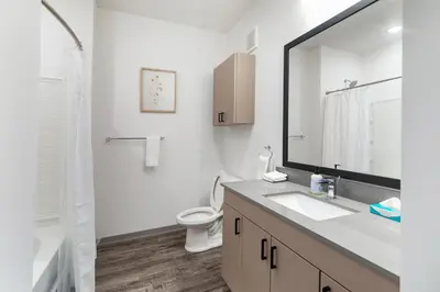 a bathroom with a sink and a toilet and a mirror at Landing Incredible 1BD Courtyard Gym