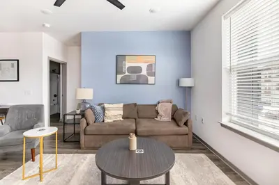 a living room with a couch and a table at Landing Incredible 1BD Courtyard Gym