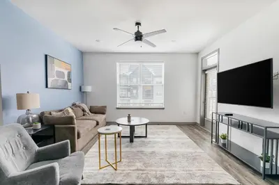 a living room with a couch and a flat screen tv at Landing Incredible 1BD Courtyard Gym