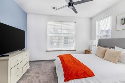 a bedroom with a bed and a flat screen tv at Landing Incredible 1BD Courtyard Gym