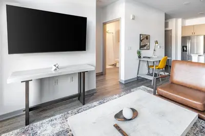 a living room with a flat screen tv on a wall at Landing Incredible 1BD Courtyard Gym