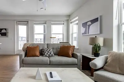 a living room with a couch and some windows at Landing Stunning 2BD in Manhattan Harbour in Cincinnati