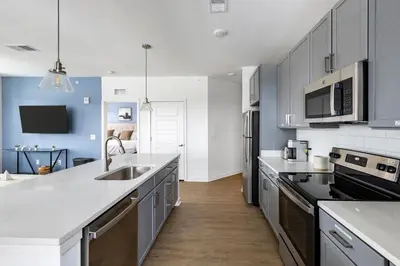 a kitchen with a sink and a counter top at Landing Stunning 2BD in Manhattan Harbour in Cincinnati