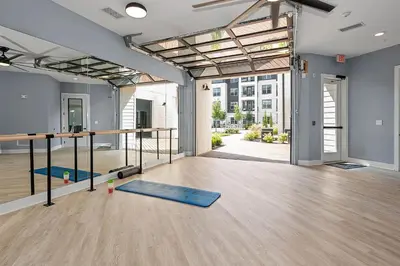 an empty room with a gym with yoga mats at Landing Stunning 2BD in Manhattan Harbour in Cincinnati