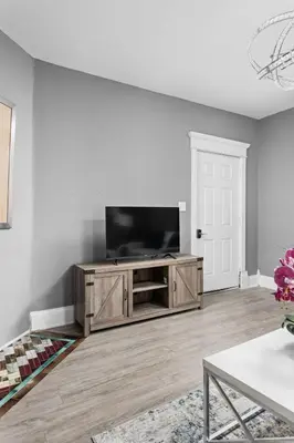 a living room with a flat screen tv at Elegant 1BR Workspace Near Parks and Summit Lake in New Castle