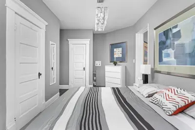 a bedroom with a bed and a painting on the wall at Elegant 1BR Workspace Near Parks and Summit Lake in New Castle