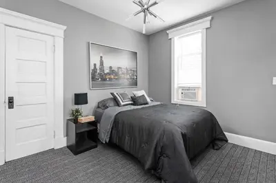 a bedroom with a large bed and a window at Stylish New Castle Escape with Garage and by Parks-Family Friendly in New Castle