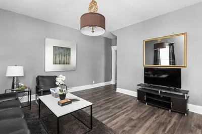 a living room with a couch and a table at Stylish New Castle Escape with Garage and by Parks-Family Friendly in New Castle
