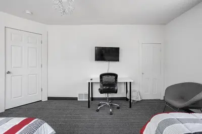 a bedroom with a desk and a chair and a television at New Castle Getaway with Fireplace Garage & Near Attractions-Family Friendly in New Castle
