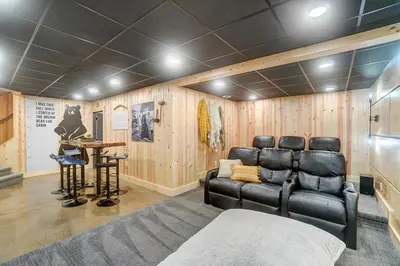 a home theater with leather chairs and a table at Family-Favorite Cabin with Private Seasonal Pool and Movie Theater in Celina