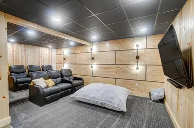 a theater room with leather chairs and a flat screen tv at Family-Favorite Cabin with Private Seasonal Pool and Movie Theater in Celina