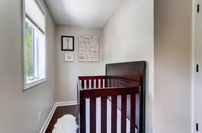 a baby room with a crib and a window at Spacious Family Gem Near Lake & State Park with Pool and Hot Tub in Celina