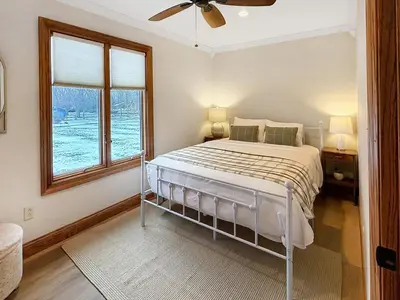 a white bedroom with a bed and a window at Grand Lake Getaway with Pool, Boat Dock - Sleeps 22 in Celina