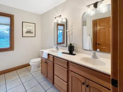 a bathroom with a sink and a toilet and a mirror at Grand Lake Getaway with Pool, Boat Dock - Sleeps 22 in Celina