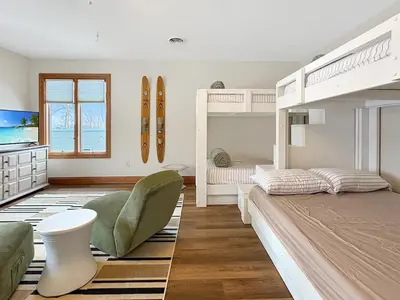 a bedroom with two bunk beds and a couch at Grand Lake Getaway with Pool, Boat Dock - Sleeps 22 in Celina