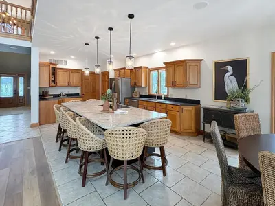 a large kitchen with a table and chairs in it at Grand Lake Getaway with Pool, Boat Dock - Sleeps 22 in Celina