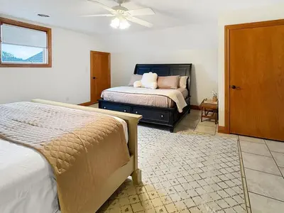 a bedroom with two beds and a ceiling fan at Grand Lake Getaway with Pool, Boat Dock - Sleeps 22 in Celina