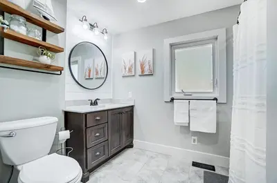 a bathroom with a toilet and a sink and a mirror at Golf Course Home with Pool and Hot Tub Near Lake and State Park in Celina