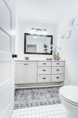 a white bathroom with a sink and a mirror at Golf Course Home with Pool and Hot Tub Near Lake and State Park in Celina