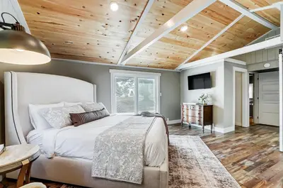 a bedroom with a bed and a wooden ceiling at Golf Course Home with Pool and Hot Tub Near Lake and State Park in Celina