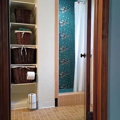 a bathroom with a shower curtain and a toilet at Cliffside Cottage in Mansfield