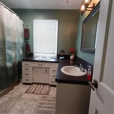 a bathroom with a sink and a mirror at Cliffside Cottage in Mansfield