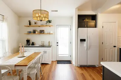 a kitchen with a table and a white refrigerator at 