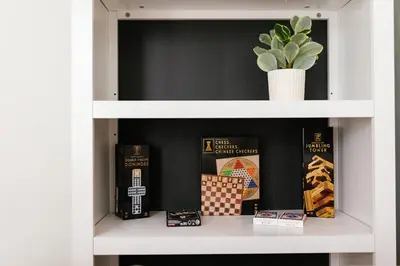 a book shelf with books and a potted plant at 