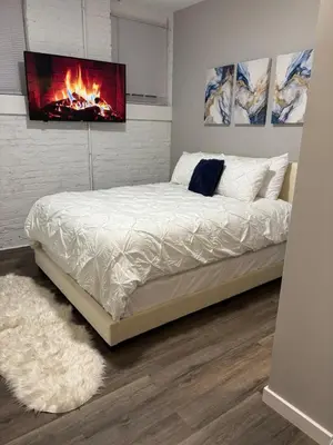 a bedroom with a bed with a fireplace on the wall at Brand new listing Aimi Luxury Retreat in Dayton