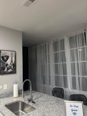 a kitchen with a sink and a window with curtains at Brand new listing Aimi Luxury Retreat in Dayton
