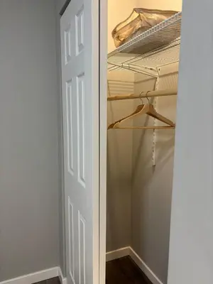 a closet with a white door and a bed at Brand new listing Aimi Luxury Retreat in Dayton