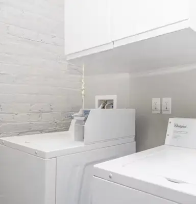 a white kitchen with white cabinets and a sink at Brand new listing Aimi Luxury Retreat in Dayton