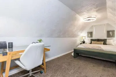 a bedroom with a desk and a bed at The Beautiful Jenkins Getaway in Columbus
