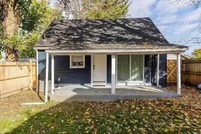 a small blue house with a fence at The Beautiful Jenkins Getaway in Columbus