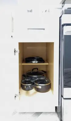 two pots and pans in a cabinet in a kitchen at The Beautiful Jenkins Getaway in Columbus