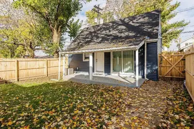 a small house in a yard with a fence at The Beautiful Jenkins Getaway in Columbus